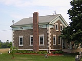 Greek Revival style farmhouse with pebble-array facing